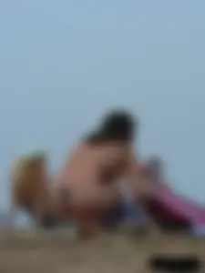 Sexy babe with a nice body topless and in a thong on the beach