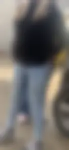 Cute teen in tight blue jeans with her hands in her back pockets