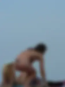 Sexy babe with a nice body topless and in a thong on the beach