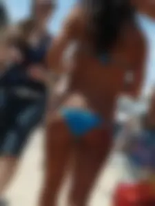 Tanned Girl in Blue Bikini Swimsuit on the Beach Candid Photo