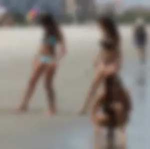 Brunette and redhead on the beach in bikinis looking sexy