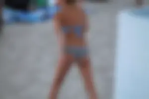 Sexy girl playing beach volleyball in a bikini
