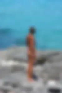 Older lady on a nude beach showing her body