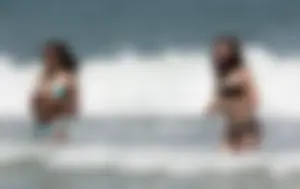 Brunette and redhead on the beach in bikinis looking sexy