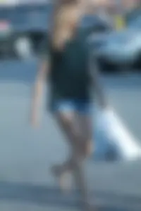 Cutie walking in the parking lot in jean shorts