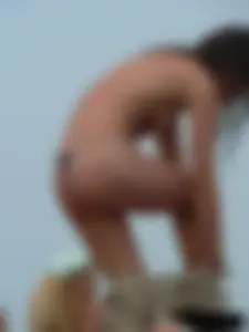 Sexy babe with a nice body topless and in a thong on the beach