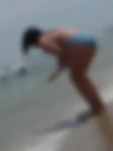 Thick brunette on the beach in a bikini with big boobs