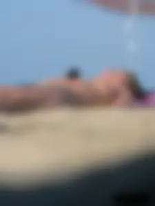 Sexy babe with a nice body topless and in a thong on the beach