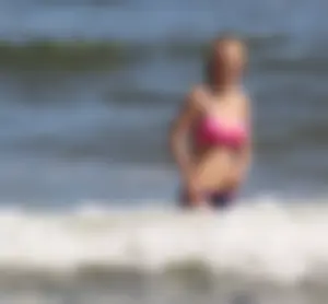 Two sexy beach teens in bikinis, one thick and one skinny with big boobs