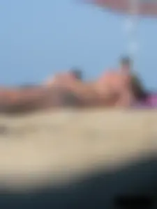 Sexy babe with a nice body topless and in a thong on the beach
