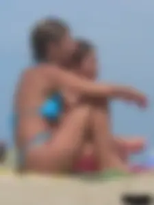 Sexy lady on the beach in a blue thong bikini