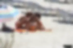 Topless milf and her topless daughter on the beach