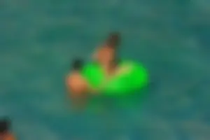 FKK Nudists playing in the water with floater