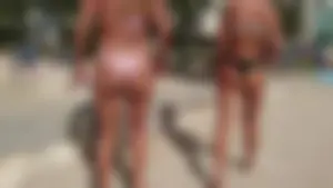 Two hot blonde friends in thong bikinis at the beach