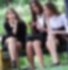Group of Girls in Pantyhose Sitting on a Park Bench Creepshots - One of Them Noticing the Photographer
