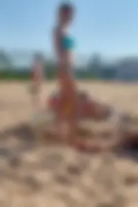 Sexy blonde milf on the beach in blue thong bikini and showing nice camel toe