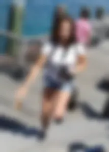 Pretty girl with a camera in little denim shorts
