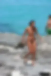 Older lady on a nude beach showing her body
