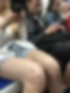 Candid girl in denim shorts sitting in a subway train, hot legs with pale skin