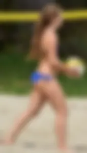 Cute girl playing volleyball in her little bikini