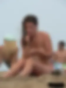 Sexy babe with a nice body topless and in a thong on the beach