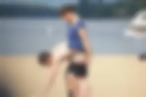 Sexy girl on the beach laying out and bending over in her bikini