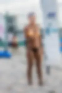 Hot girls playing beach volleyball in bikinis and shorts
