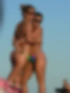 Bunch of sexy babes on the beach topless and in thong bikinis