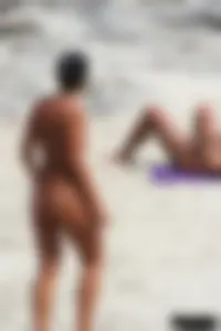 Smoking milf at a nude beach with a hairy pussy