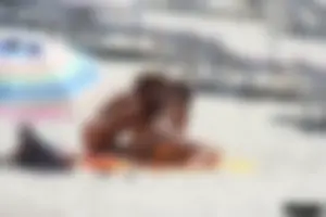 Topless milf and her topless daughter on the beach