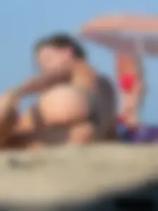 Sexy babe with a nice body topless and in a thong on the beach