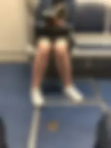 Stocky Girl in a Skirt Reading a Book in Subway Train with Slighty Spread Legs
