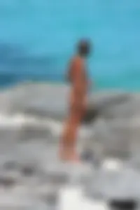 Older lady on a nude beach showing her body