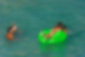 FKK Nudists playing in the water with floater