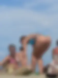 Sexy lady on the beach in a blue thong bikini