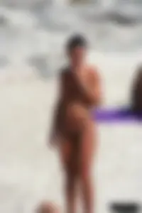 Smoking milf at a nude beach with a hairy pussy