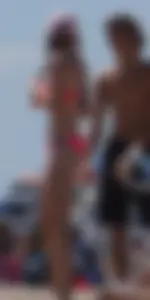 Sexy and skinny girl on the beach in pink bikini