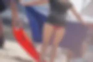 A group of teens in bikinis on the beach