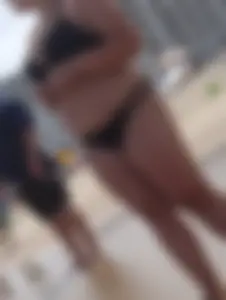Thick beach girl in black bikini with big ass and tits