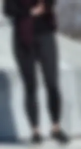 Brunette with glasses on the phone in tight patterned leggings