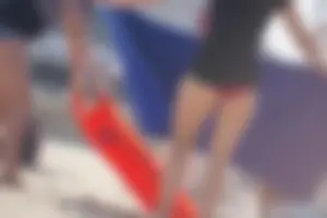 A group of teens in bikinis on the beach