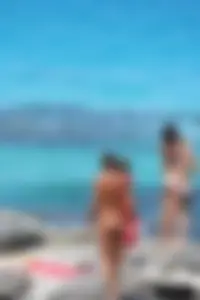 Older lady on a nude beach showing her body