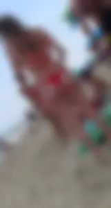 Sexy girl at the beach in a red thong bikini with nice tits and ass
