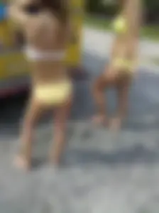 Two sexy babes in yellow bikinis at an ice cream truck