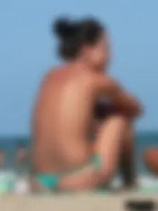 Bunch of sexy babes on the beach topless and in thong bikinis