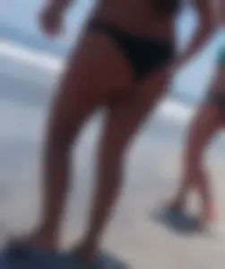 Thick brunette beach babe booty in a little black bikini