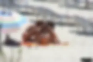 Topless milf and her topless daughter on the beach