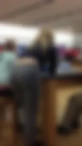 Teen in grey tights and a top bending over