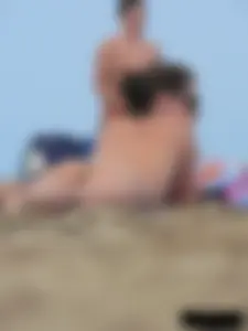 Sexy babe with a nice body topless and in a thong on the beach