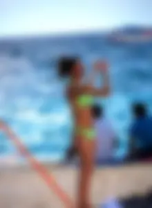 A few sexy girls with great asses in thong bikinis at the beach